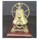 Vintage brass nautical bell on a wood base