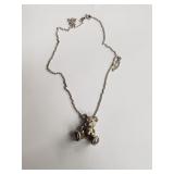 18k gold and 925 silver bear pendant on a