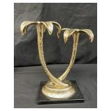 Metal palm tree candle holders on marble base