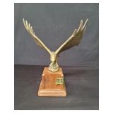 Brass eagle sculpture on a wood base