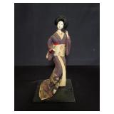 Vintage Japanese geisha doll on wood stand