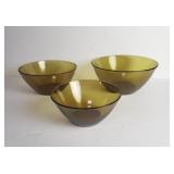 Three amber glass mixing bowls