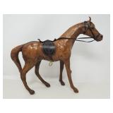 Carves wood horse figure with leather details