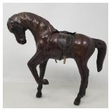 Carved wood horse figure with leather details