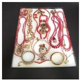 Group of costume jewelry in rikers display case