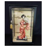 Japanese geisha doll in a display case