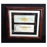 Framed antique First National Bank checks