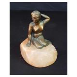 Vintage copper mermaid nude figure on a pink