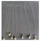 Group of filigree pendant necklaces with tiny