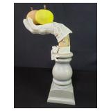Gloved hand fruit bowl on pedestal base