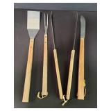 Four stainless steel and wood BBQ tools