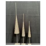 Group of glitter covered metal Christmas trees