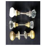 Three vintage glass and brass doorknobs
