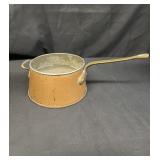 Vintage copper saucepan with brass handle
