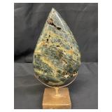 Green stromatolite jasper specimen on stand