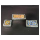 Three tin and tile trinket boxes