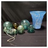 Group of glass fishing floats and vase