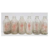 Group of Yellis Dairy glass milk bottles with