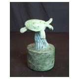 Bronze turtle sculpture on a marble base