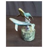 Brass whales sculpture on a marble base