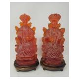 Pair of carved resin seated figures of emperor