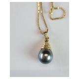 14k gold and Tahitian pearl pendant on a 14k gold
