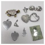 Silver tone brooches and charms