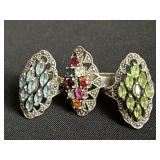 Group of three sterling silver rings with colored