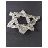 Silver brutalist star of David sculpture