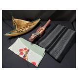 Box of cardboard boats and scarfs