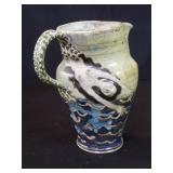 Mid century signed pottery pitcher with a m