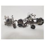 3 scrap metal art depicting motorcycles