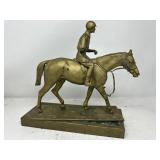 Patinated bronze jockey on horse statue