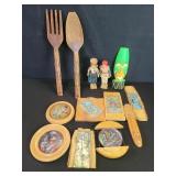 Group of wood and enamel wall plaques and carved