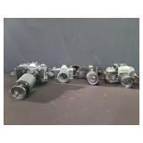 Three  vintage Nikon cameras and 1 Olympus