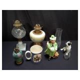 Vintage oil lamps, ceramic figurines, and mug