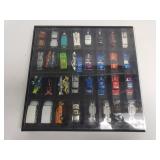 Collection of vintage hot wheels in a display case