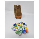 Collection of vintage marbles in a leather pouch