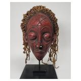 Vintage African carved wood mask on metal stand