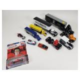 Group of toy cars, semi-trucks, and F1