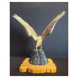 Brass eagle sculpture on wood stand