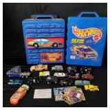 Group of toy cars and empty Hot Wheels car cases