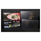 Four signed NASCAR die cast model cars with