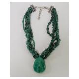 Multi- strand jade necklace with a large drop