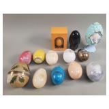 Collection of marble, brass, and glass eggs