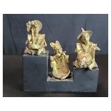 Three tribal style brass musician figures on a