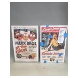 Pair of reproduction poster prints in glass