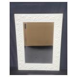 Vintage beveled mirror with carved wood floral