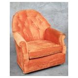 Vintage upholstered club chair on casters