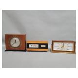 Three vintage wood and brass electric table clocks